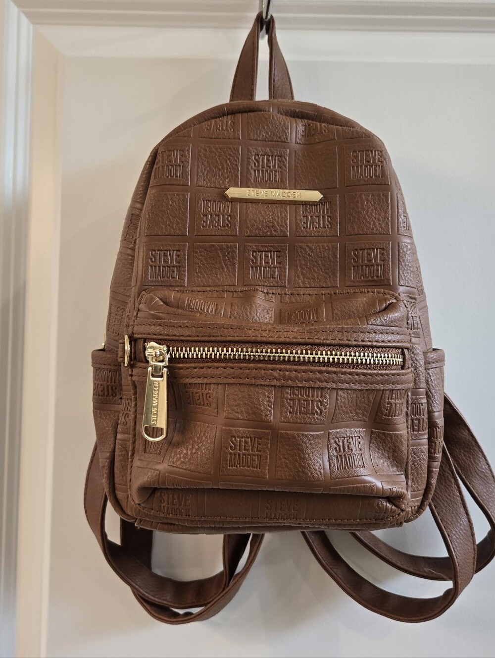 Steve Madden Brown Embossed Mini Backpack with Signature Logo.